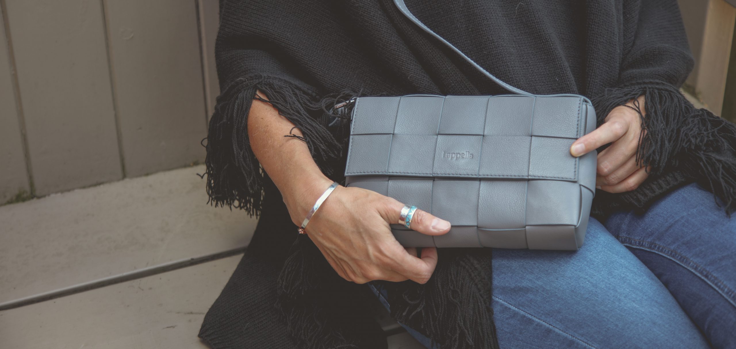 Lappella Alicia luxury soft Valentino leather crossbody bag in morning blue. Lifestyle shot.