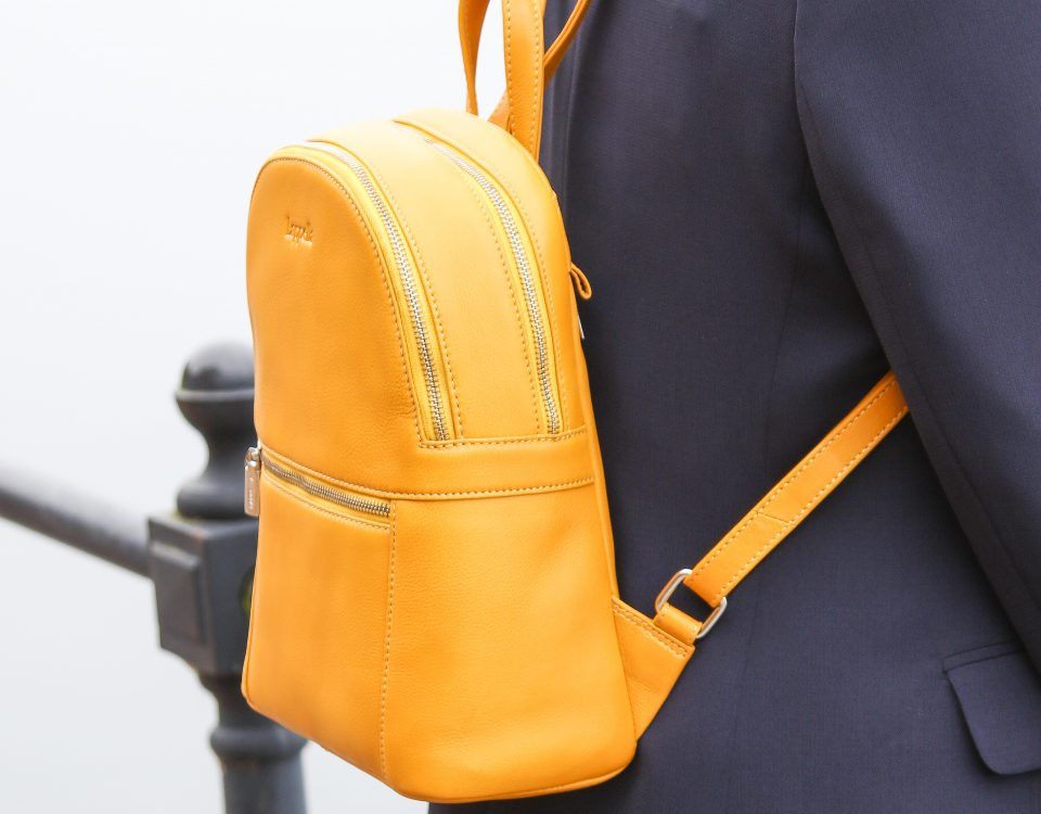 Nicole soft leather backpack in mustard. Lifestyle shot